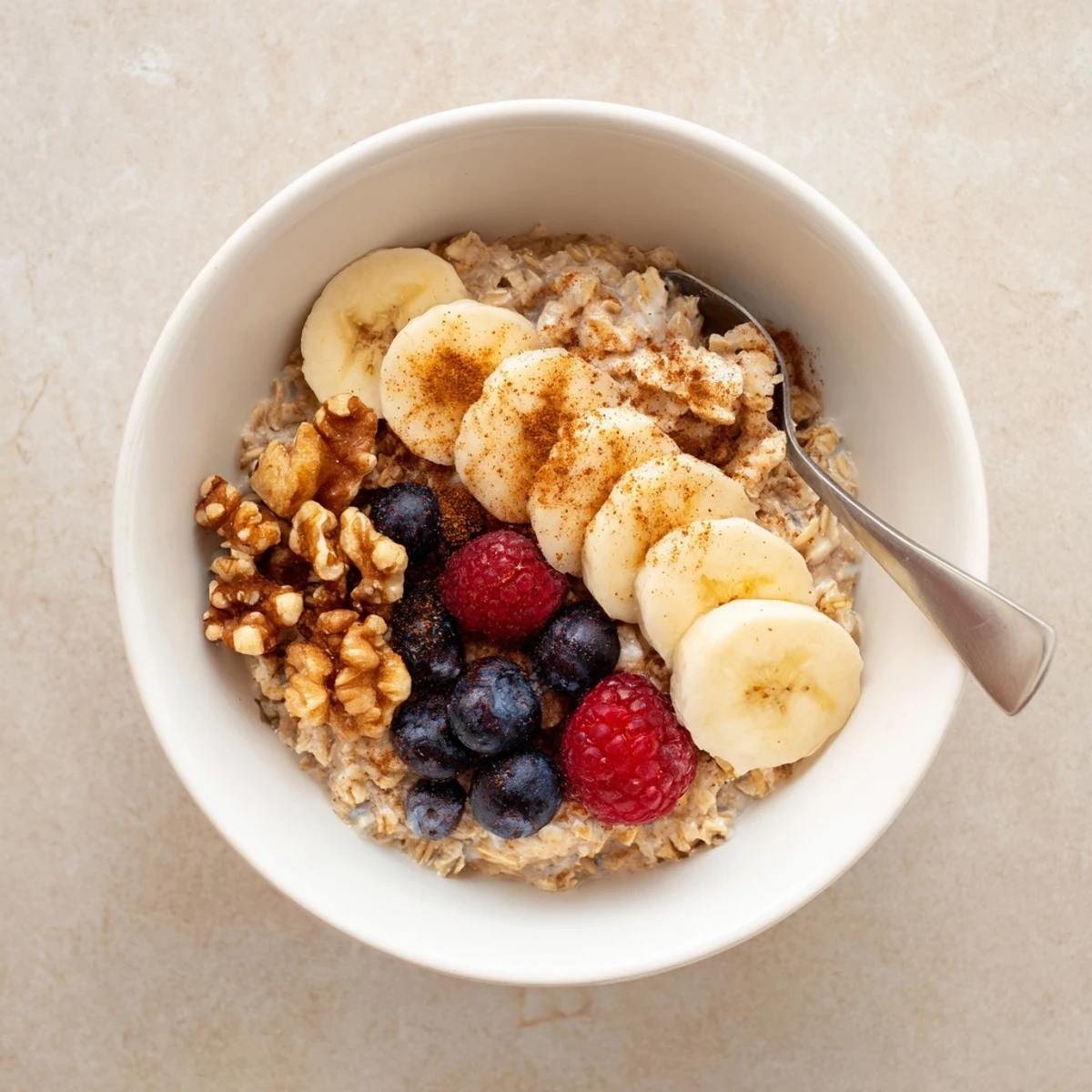 Creamy brown sugar overnight oats topped with fresh banana slices and crunchy chopped walnuts in a glass jar