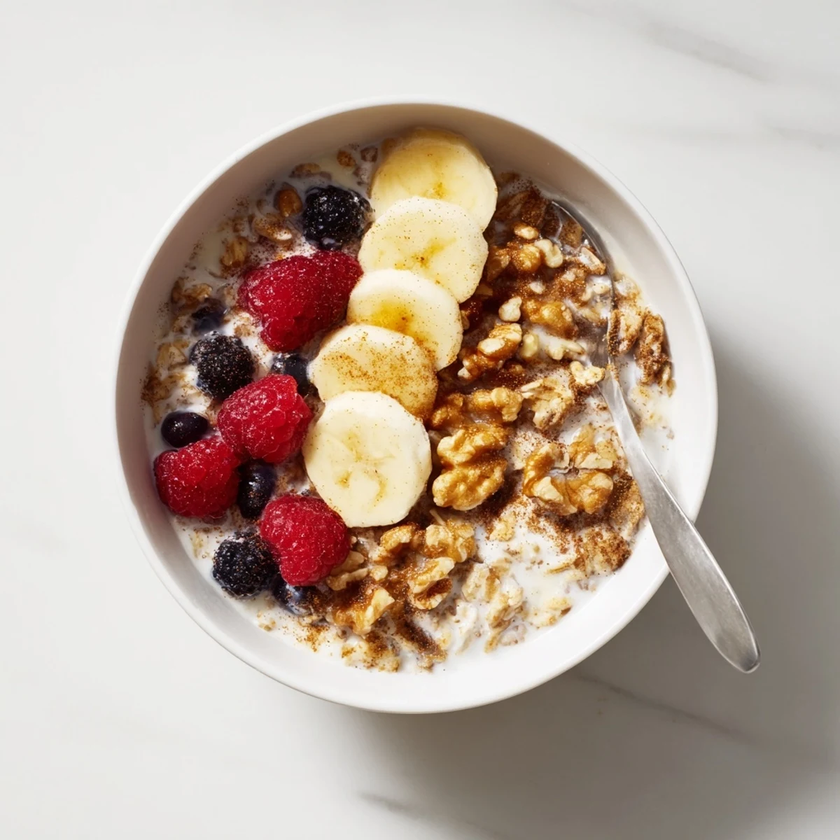 Spoonful of chilled brown sugar overnight oats showing rich texture with vanilla, pecans, and apple slices on top