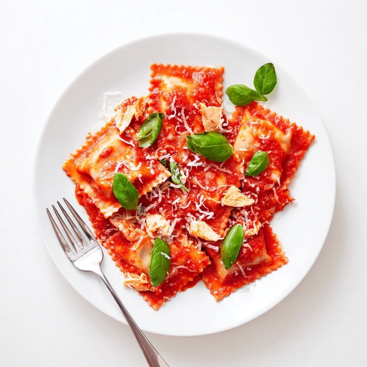 Homemade chicken and mushroom ravioli served over vibrant red tomato sauce with fresh basil