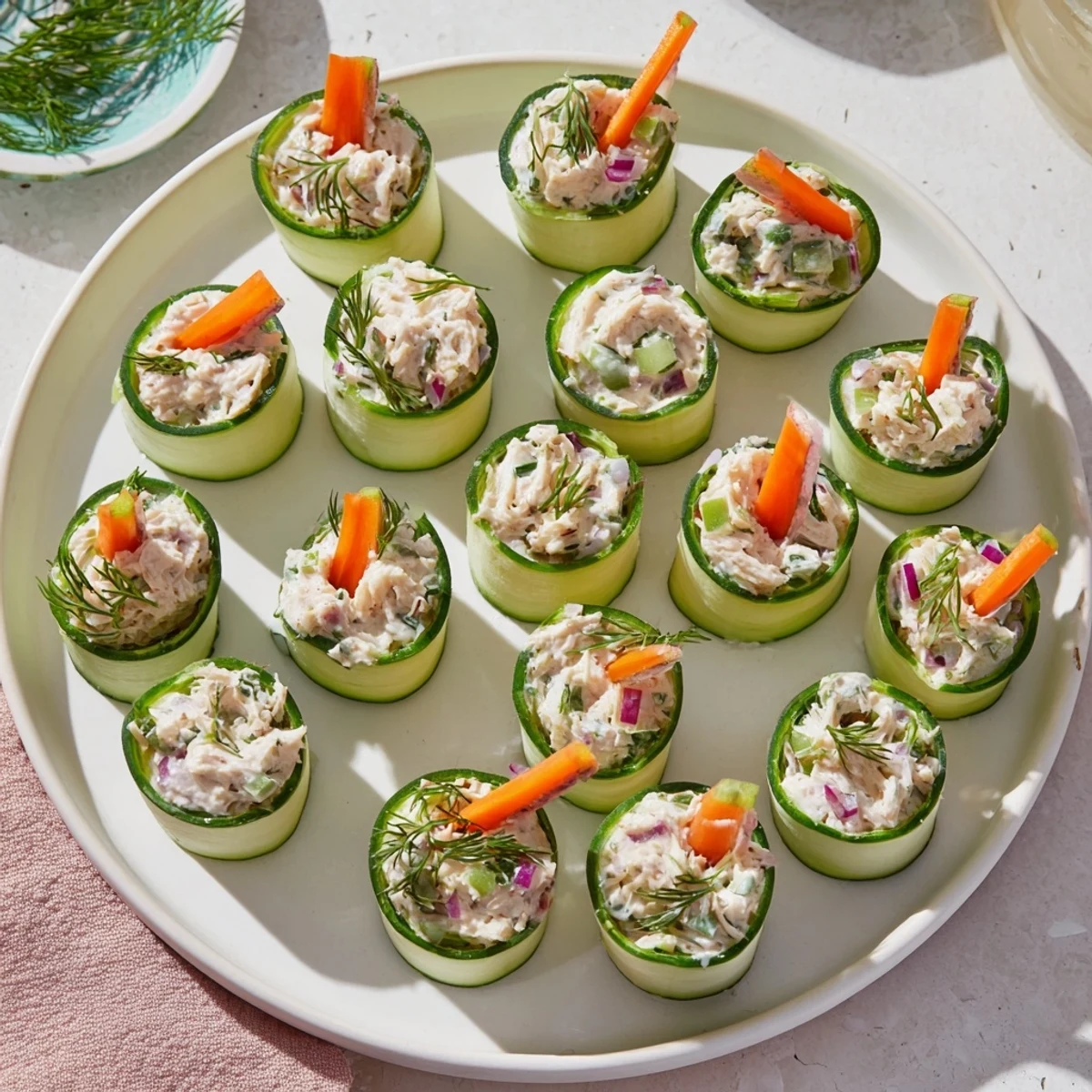 Crisp cucumber ribbons wrapped around creamy chicken salad filling for a light low carb appetizer