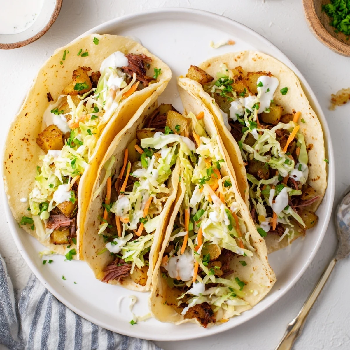 Delicious Irish tacos showcasing shredded beef, crispy potato chunks, and crunchy cabbage in tortillas