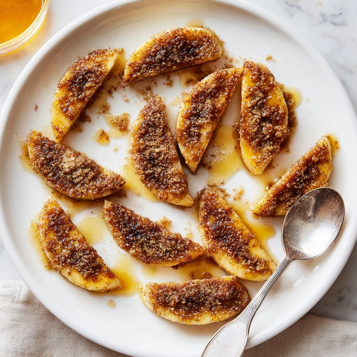 Golden pan fried cinnamon bananas sizzling in butter with caramelized edges