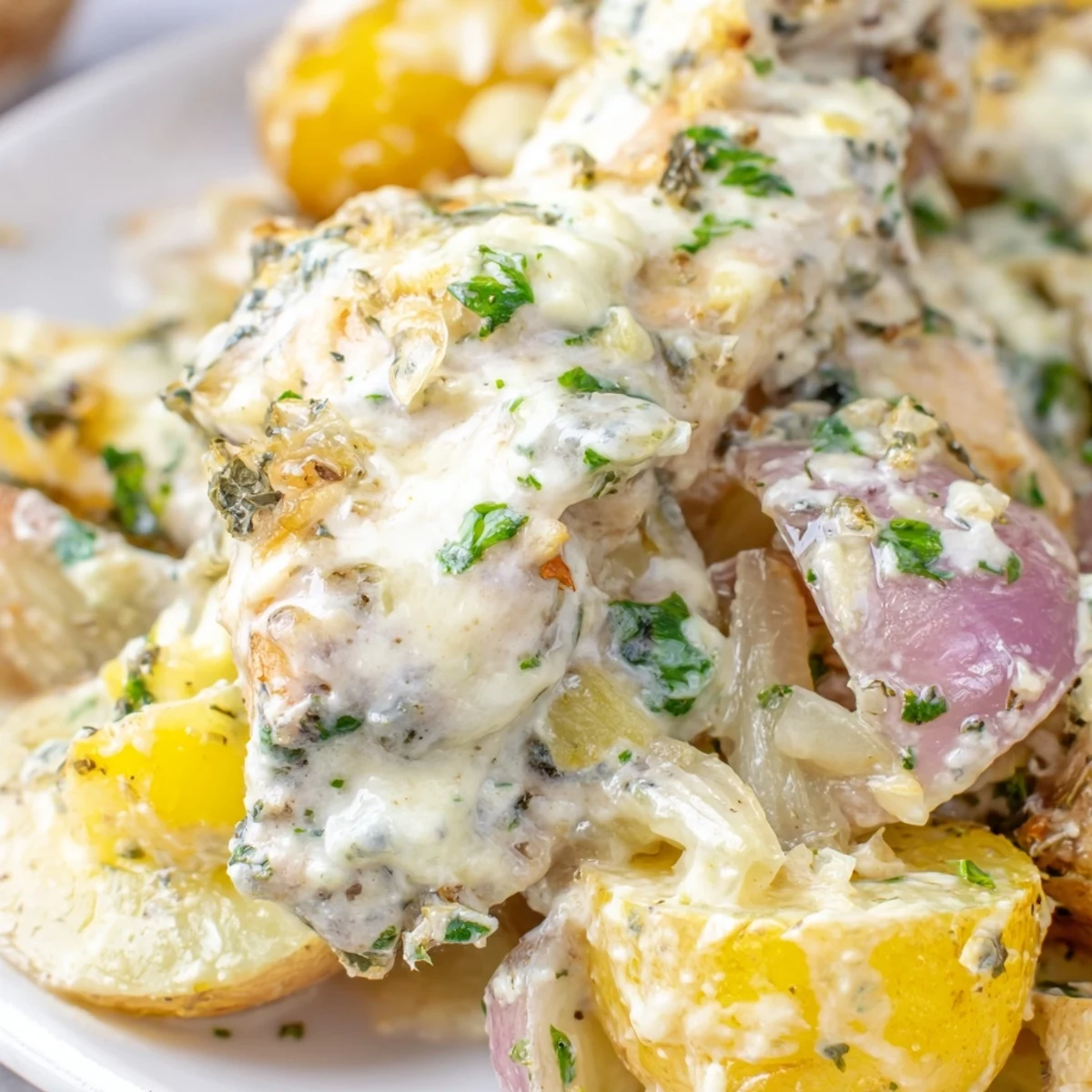 Comforting one-pot meal featuring fork-tender chicken and buttery potatoes coated in a garlic Parmesan glaze