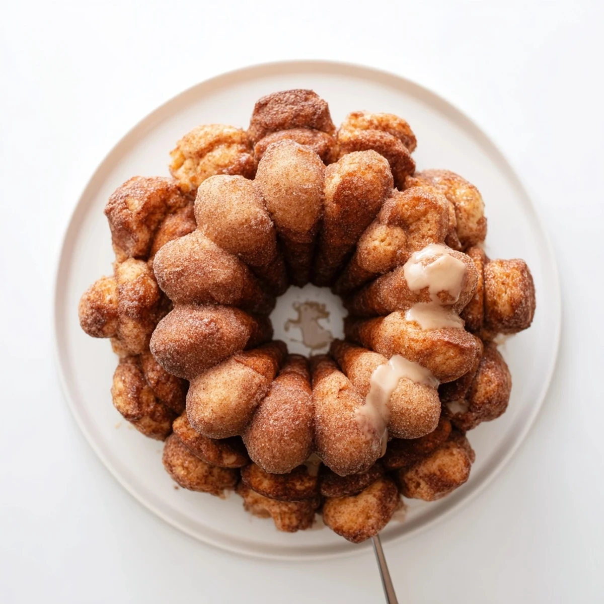 Golden high protein no sugar monkey bread with cinnamon coating on a bundt pan