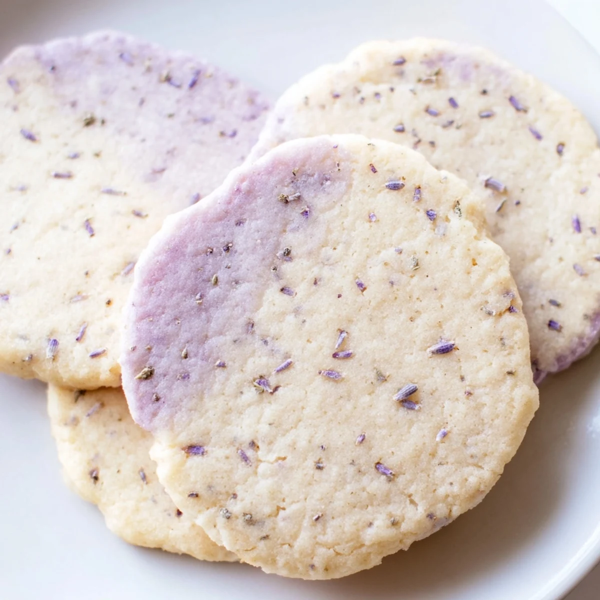Buttery lilac sugar cookies with delicate floral specks cooling on a wire baking rack