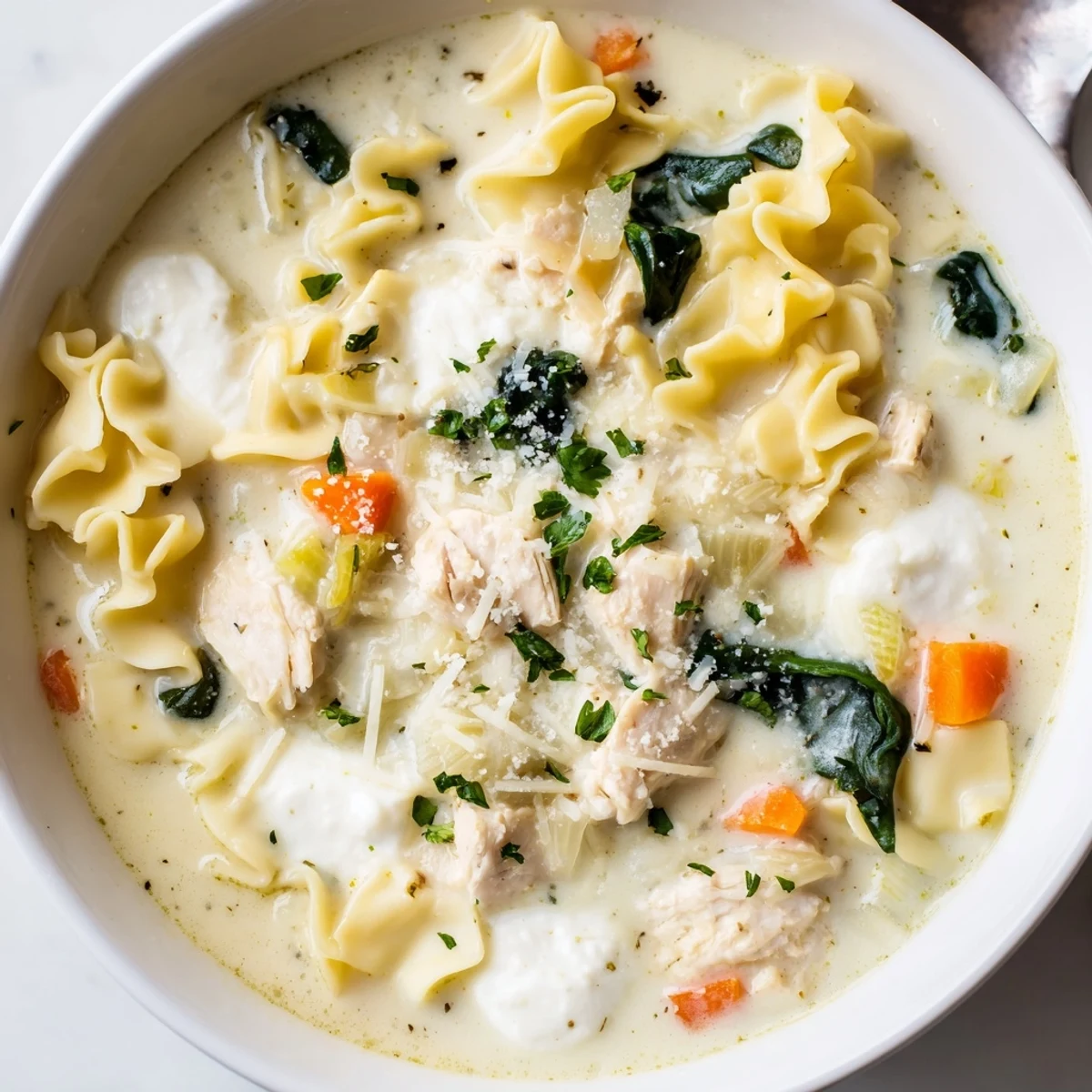 Creamy Italian White Lasagna Soup served in a rustic bowl with melted mozzarella and fresh parsley garnish