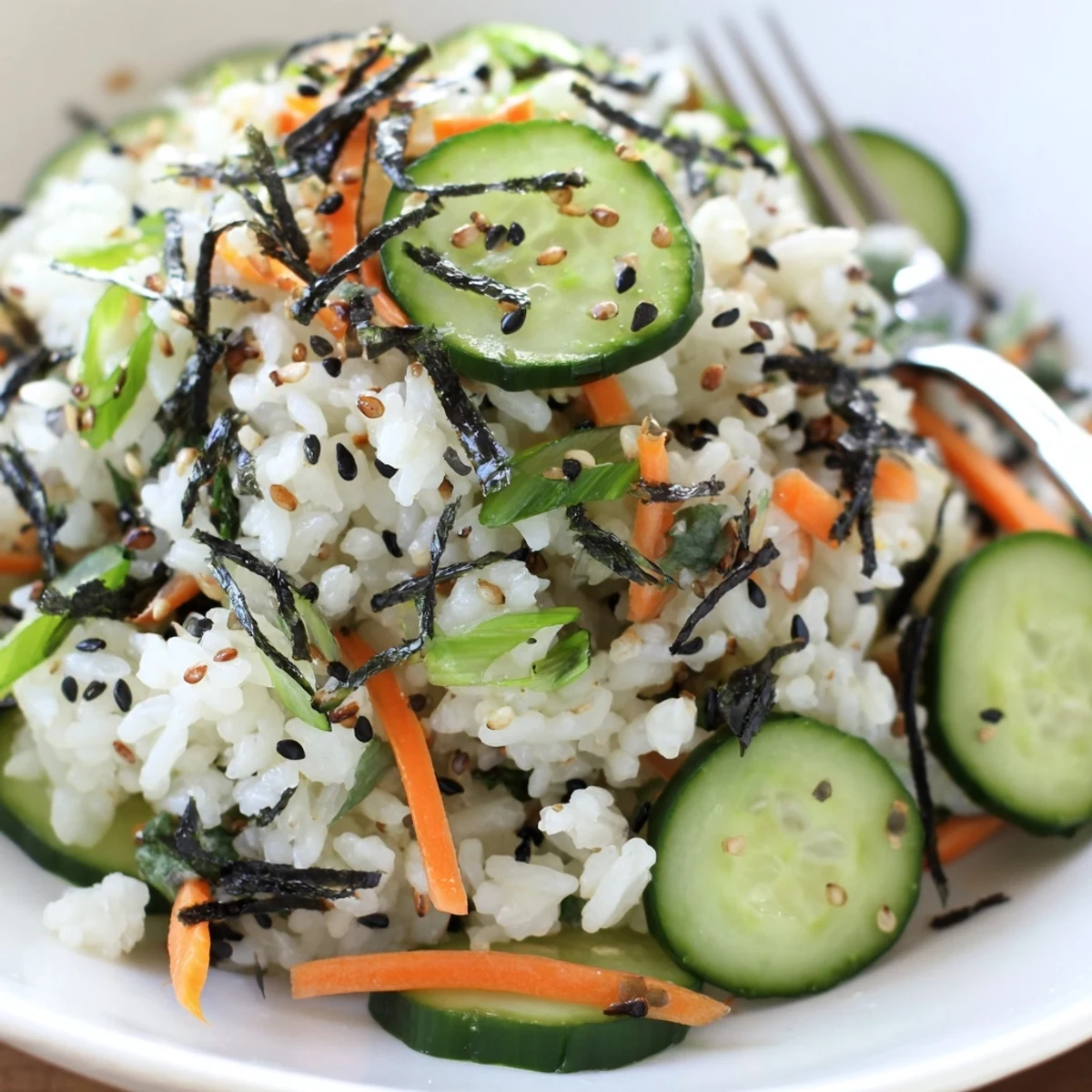 Sushi Cucumber Salad glistening with sesame oil, nori strips, chilled and crisp