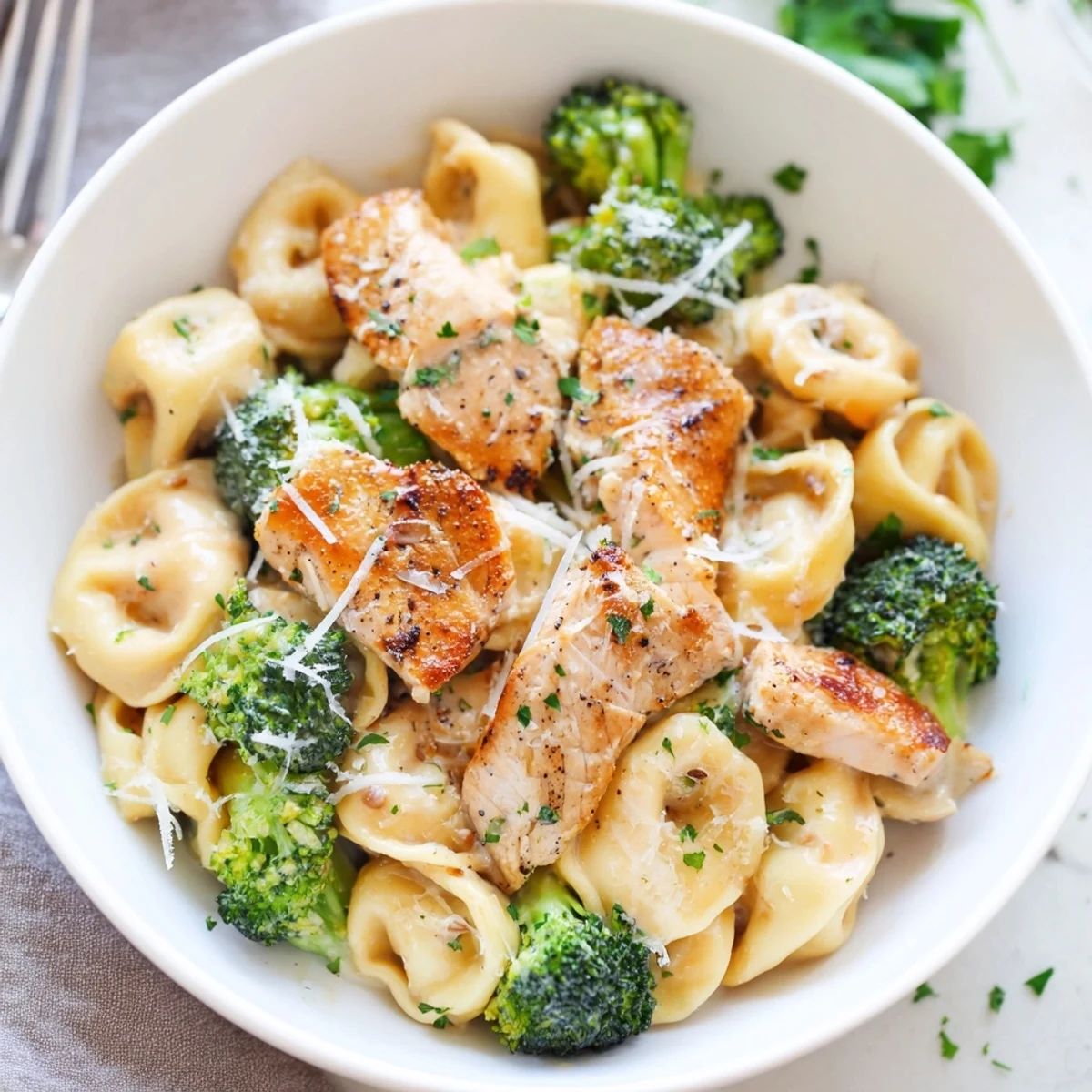 Creamy Garlic Parmesan Tortellini Chicken Broccoli Recipe plated steaming, fragrant garlic sauce, Parmesan sprinkle