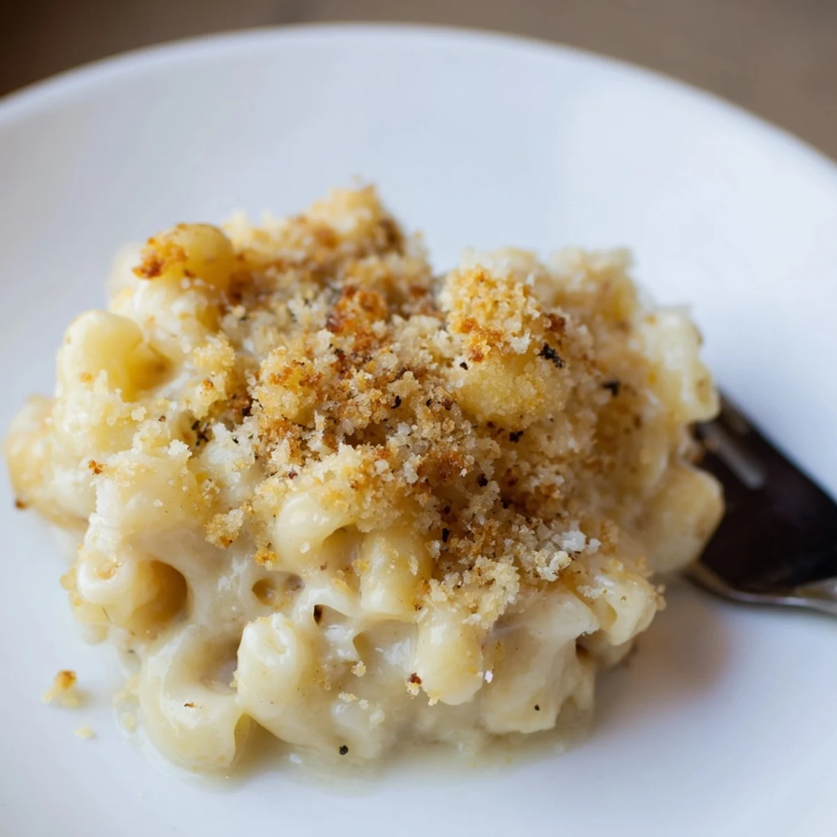 Creamy Mac And Cheese bubbling in dish, golden breadcrumbs, steam rising