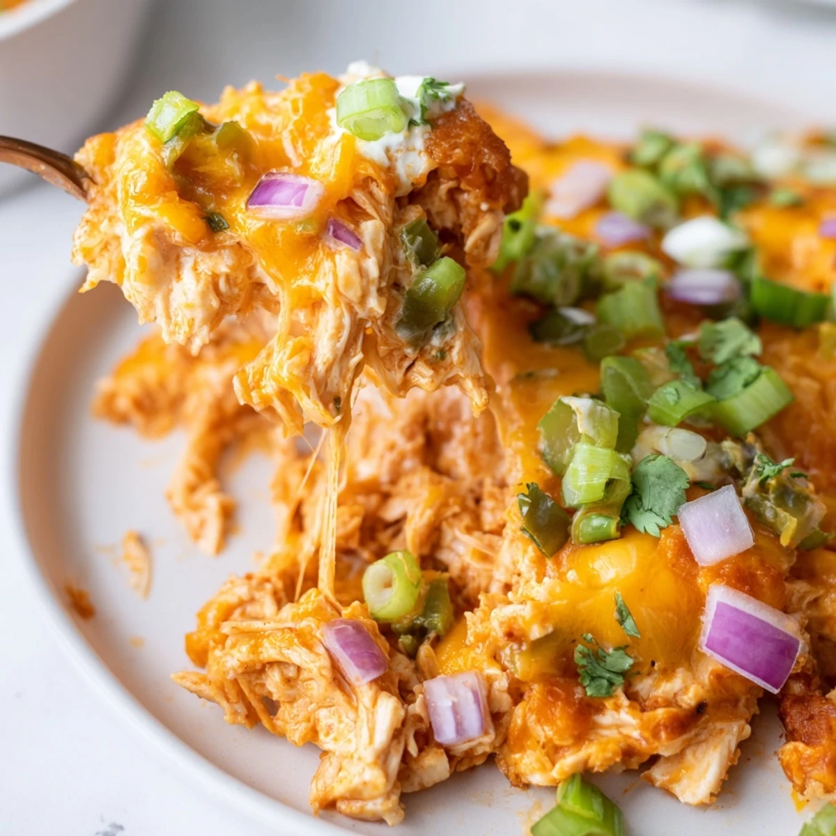 Golden baked jalapeno buffalo chicken casserole with melted cheddar and bubbling buffalo sauce