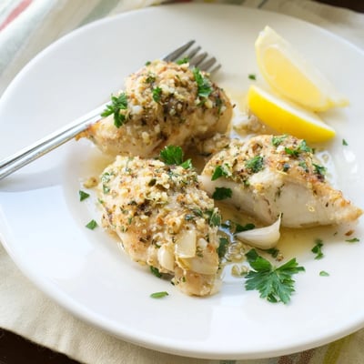 Juicy garlic butter baked chicken breast sliced open to reveal tender, perfectly cooked meat