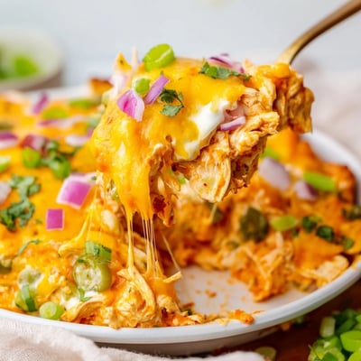 Creamy jalapeno buffalo chicken casserole topped with gooey melted cheese and fresh cilantro